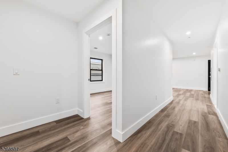 180 Carroll Street Paterson, NJ 07501 - Photo 18 of 31 a view of a hallway with wooden floor