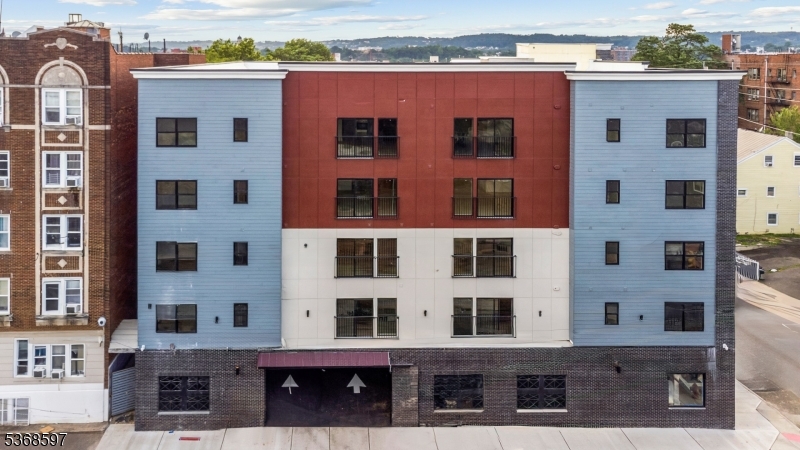 180 Carroll Street Paterson, NJ 07501 - Photo 2 of 31 a front view of a building with glass windows
