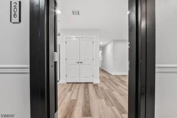 a view of a hallway with wooden floor