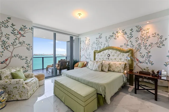 a bedroom with a bed and large window