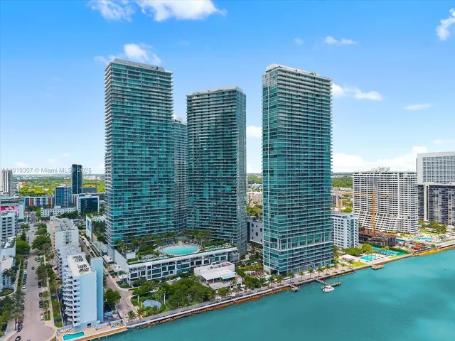 a view of kitchen with kitchen island a sink and living room view