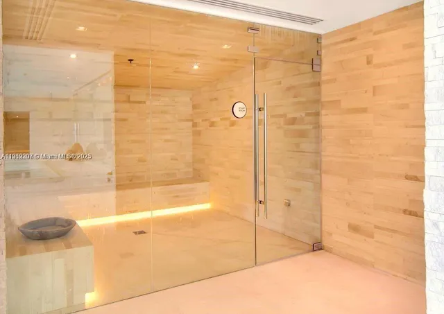 a room with pool table and windows