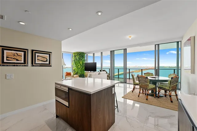 a view of a dining room with furniture and a kitchen