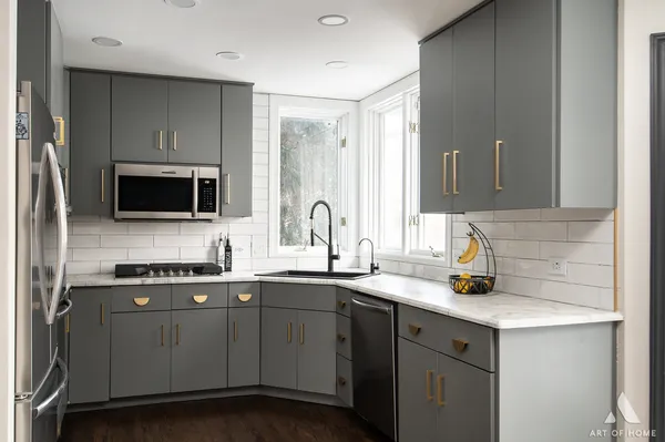 a kitchen with a sink and stainless steel appliances