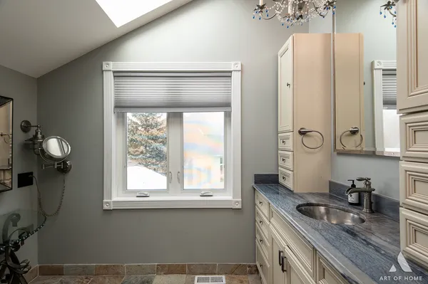 a kitchen with stainless steel appliances granite countertop a sink dishwasher a refrigerator and a stove with granite countertops