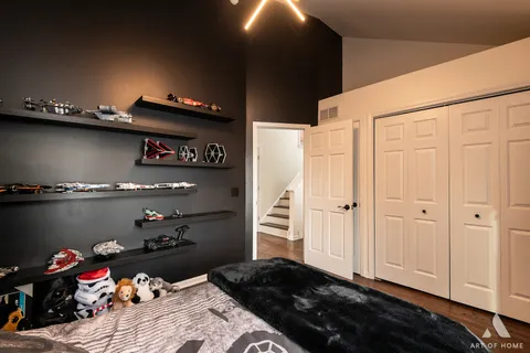 a bathroom with a granite countertop sink toilet a mirror and shower curtain