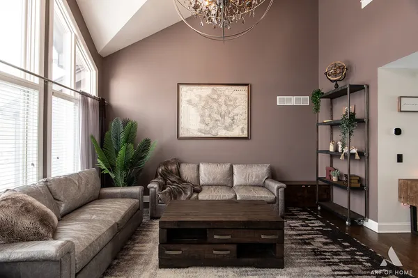 a living room with furniture and a potted plant
