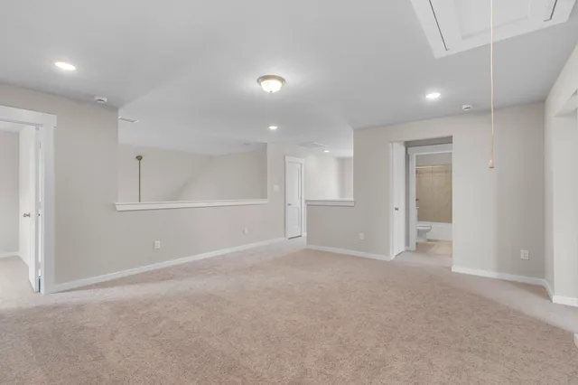 a large kitchen with granite countertop a stove a sink a window and wooden floor