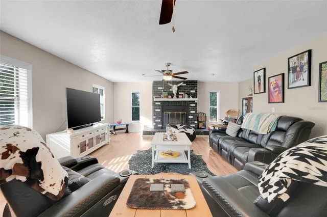a living room with furniture a couch and a flat screen tv