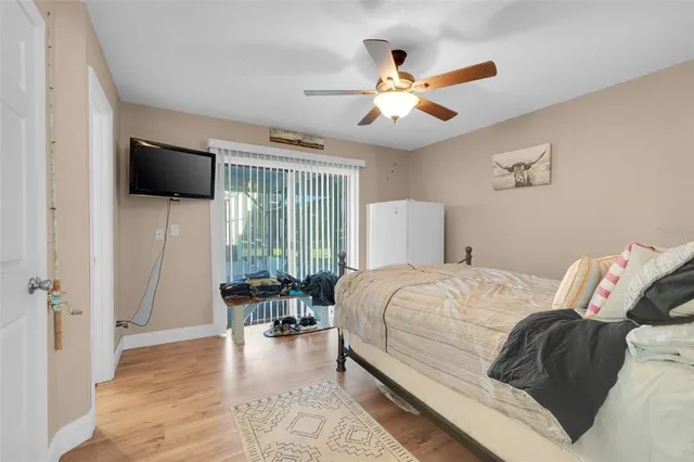 a bedroom with a large bed and a window