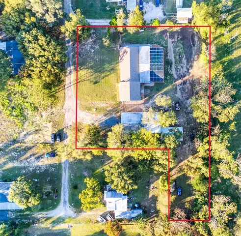 a vase of flowers sitting in front of a house