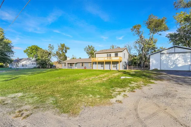 a view of a house with a backyard