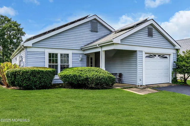 a front view of a house with a garden