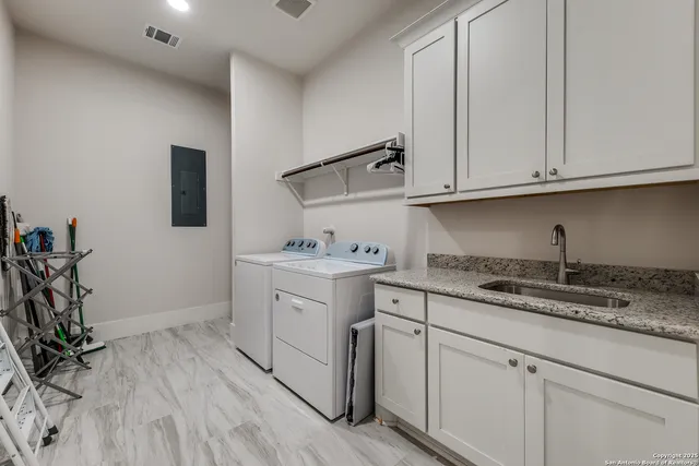 a kitchen with granite countertop white cabinets and white appliances