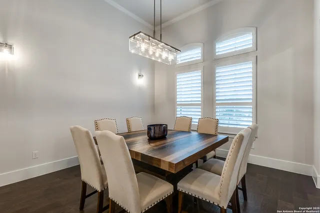 a view of a dining room with a table and chairs