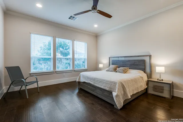 a large bed sitting in a bedroom next to a window