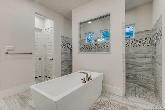 a bathroom with a bathtub and shower