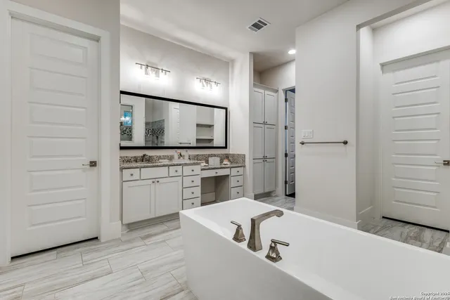 a view of a kitchen with a sink stove and cabinet