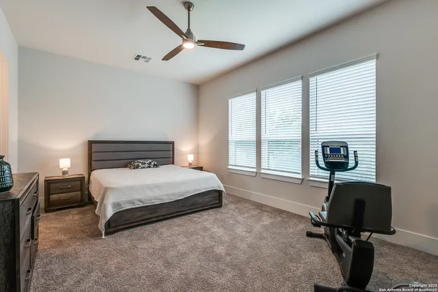 a bedroom with a bed a desk and a window