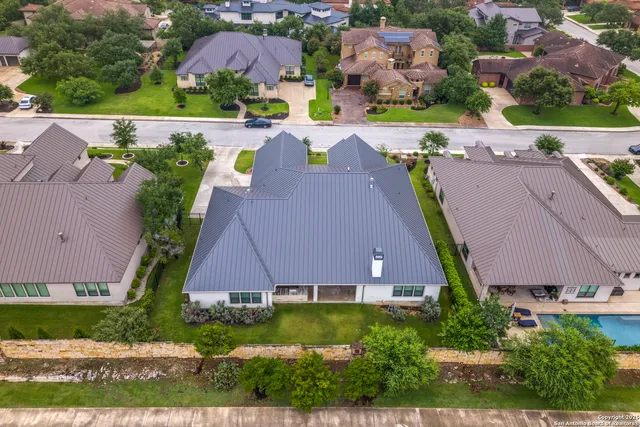 an aerial view of multiple houses with yard