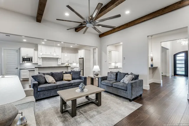 a living room with furniture and a wooden floor