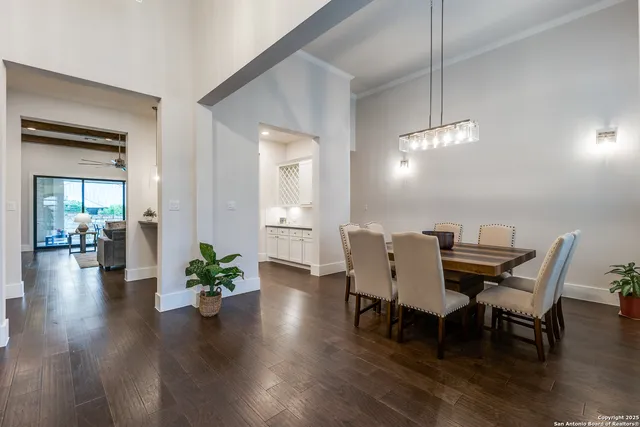 a view of a dining room with furniture wooden floor and chandelier
