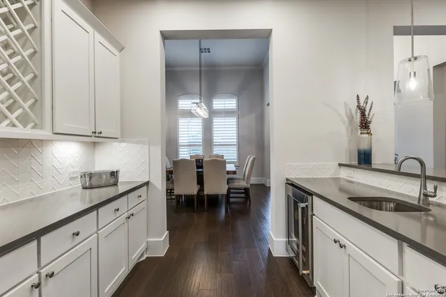 a kitchen with sink cabinets and wooden floor