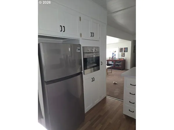 a kitchen with stainless steel appliances a refrigerator and cabinets