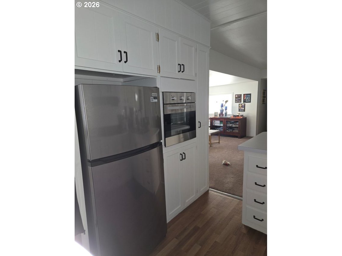 16901 Southeast Division Street Portland, OR 97236 - Photo 3 of 14 a kitchen with stainless steel appliances a refrigerator and cabinets