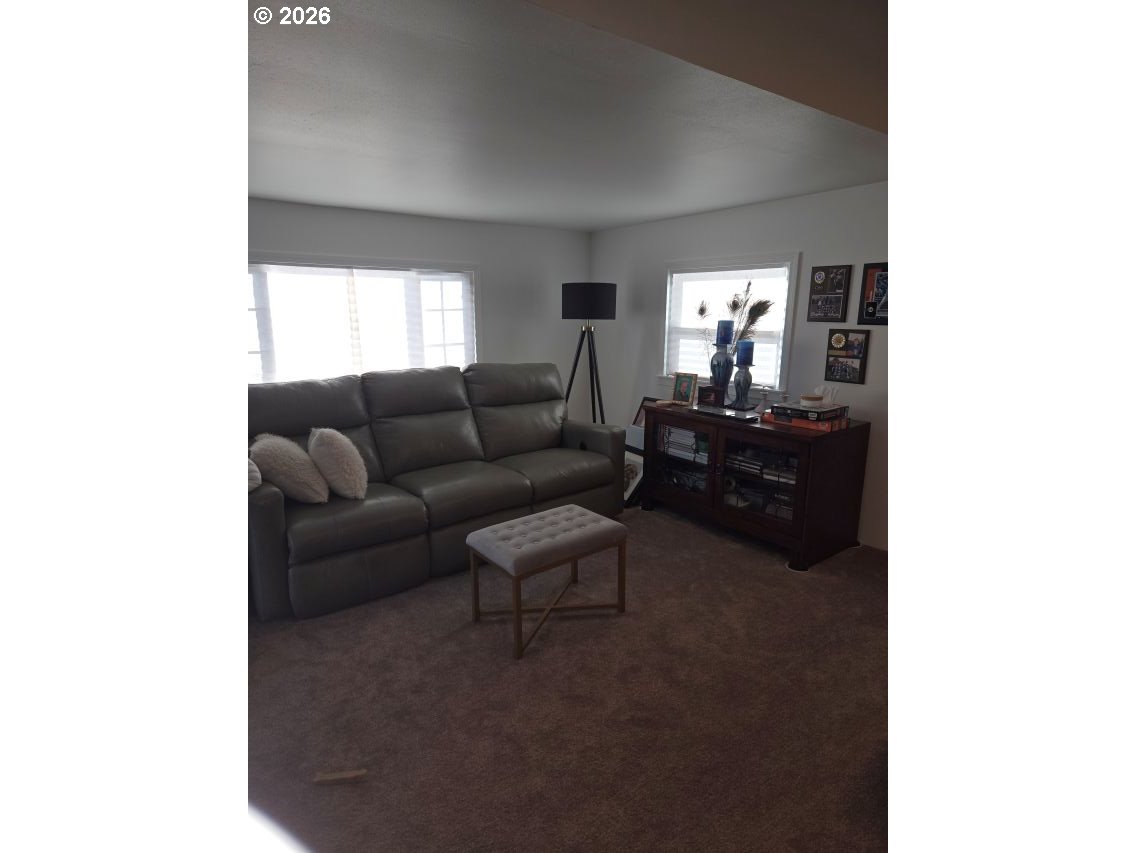 16901 Southeast Division Street Portland, OR 97236 - Photo 4 of 14 a living room with furniture and a flat screen tv