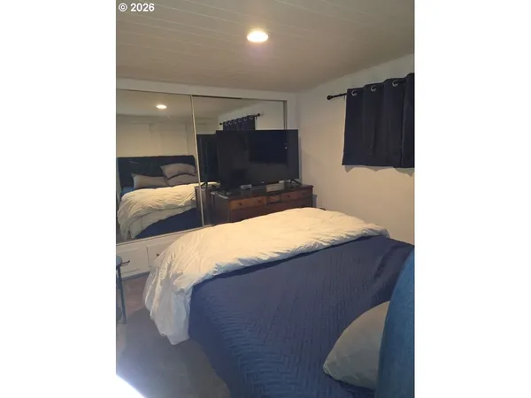 a bed room with a bed and a television