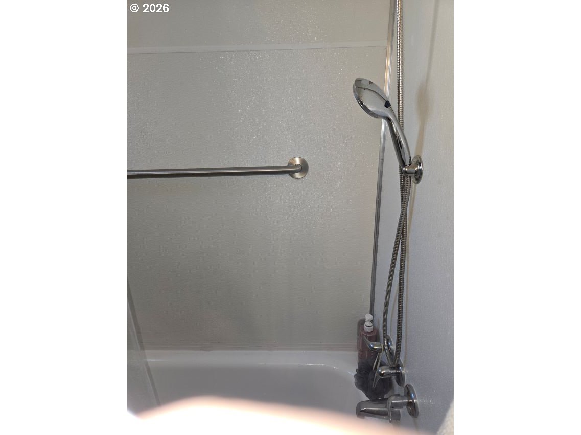 16901 Southeast Division Street Portland, OR 97236 - Photo 10 of 14 a bathroom with a glass shower door
