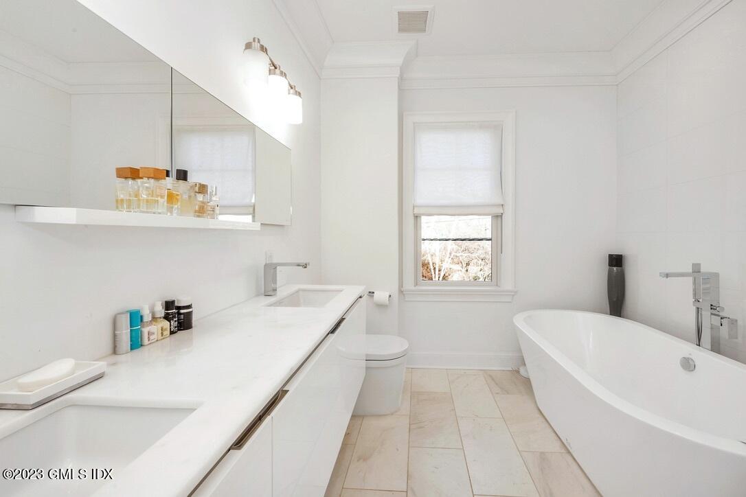 1 Home Place, Unit A Greenwich, CT 06830 - Photo 11 of 22 a bathroom with a sink a bathtub and a window