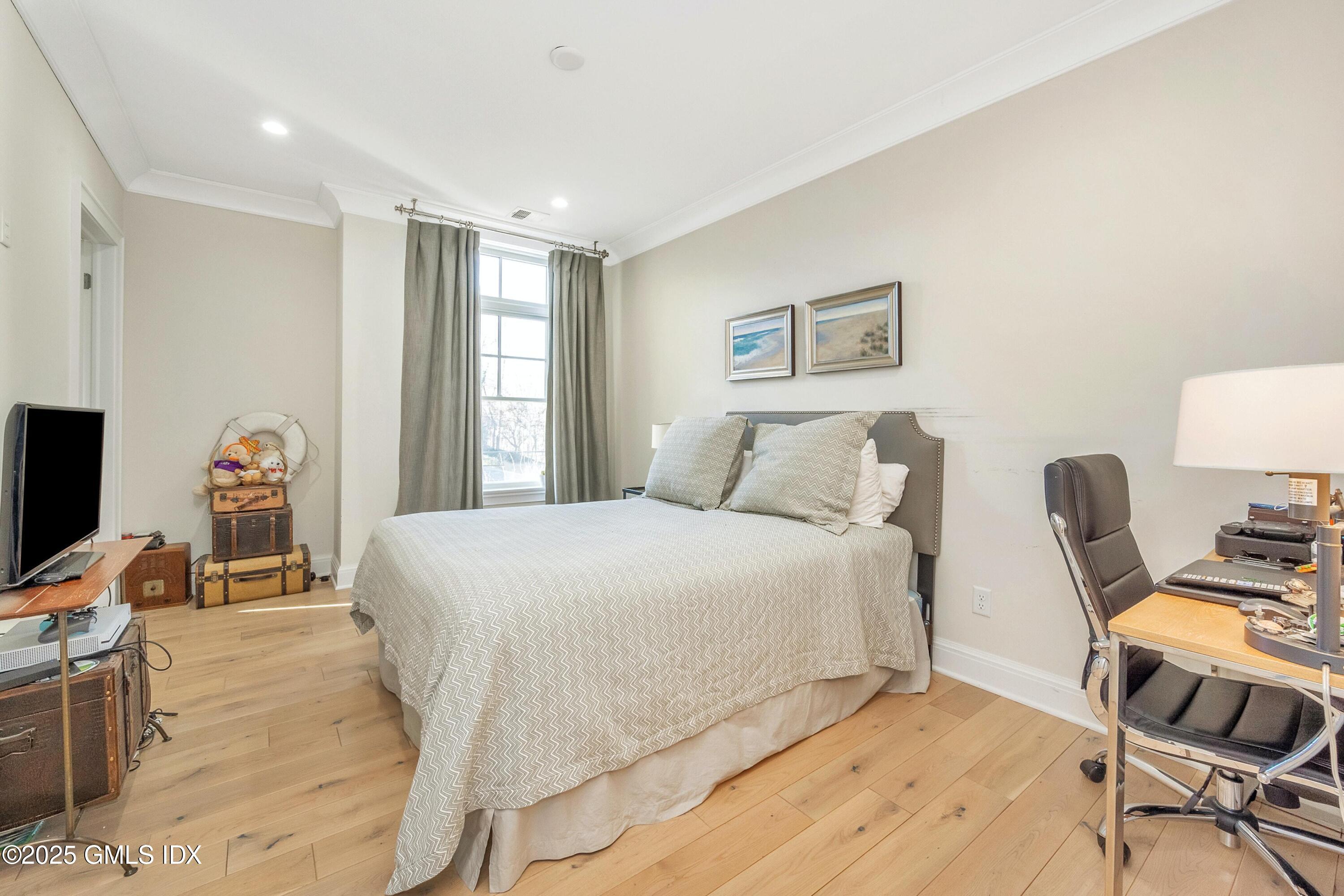 1 Home Place, Unit A Greenwich, CT 06830 - Photo 12 of 22 a bedroom with a bed and wooden floor