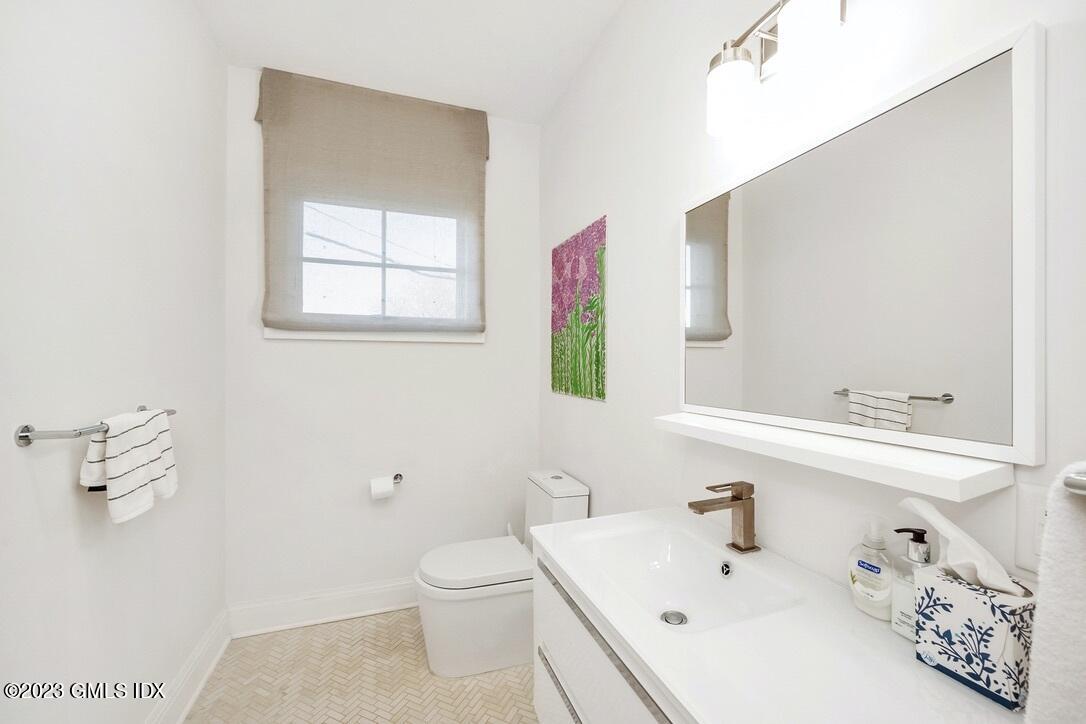1 Home Place, Unit A Greenwich, CT 06830 - Photo 13 of 22 a bathroom with a sink a toilet and mirror