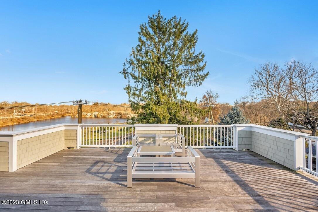 1 Home Place, Unit A Greenwich, CT 06830 - Photo 17 of 22 a view of a deck with wooden floor and fence next to a yard