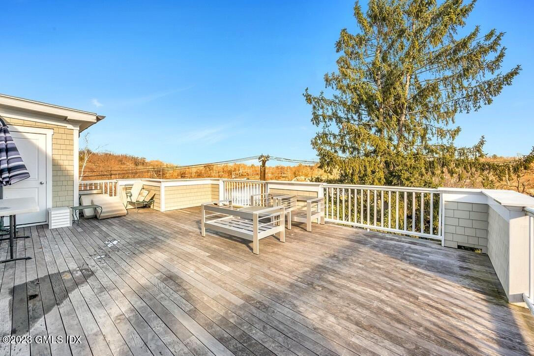 1 Home Place, Unit A Greenwich, CT 06830 - Photo 18 of 22 a view of a roof deck with wooden floor and fence