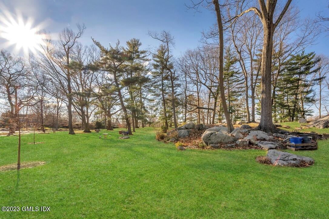 1 Home Place, Unit A Greenwich, CT 06830 - Photo 20 of 22 a backyard of a house with lots of green space and fountain