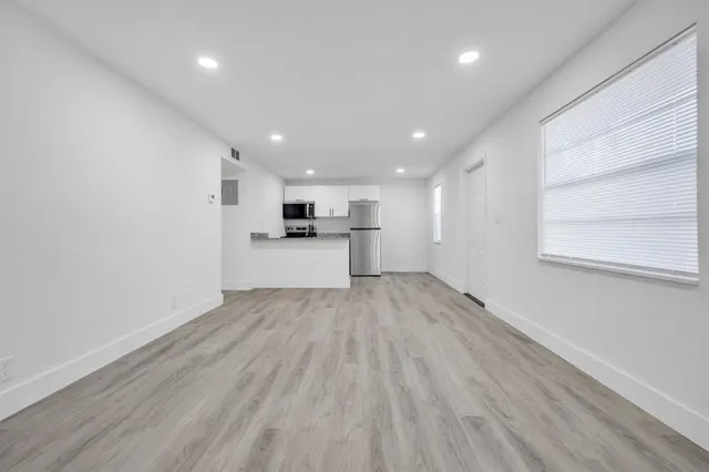 a view of a kitchen with a sink and dishwasher cabinets
