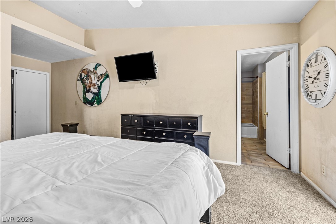 1624 Palmae Way Las Vegas, NV 89128 - Photo 9 of 18 This spacious bedroom offers ample comfort with plush carpet flooring, providing a cozy and inviting retreat.