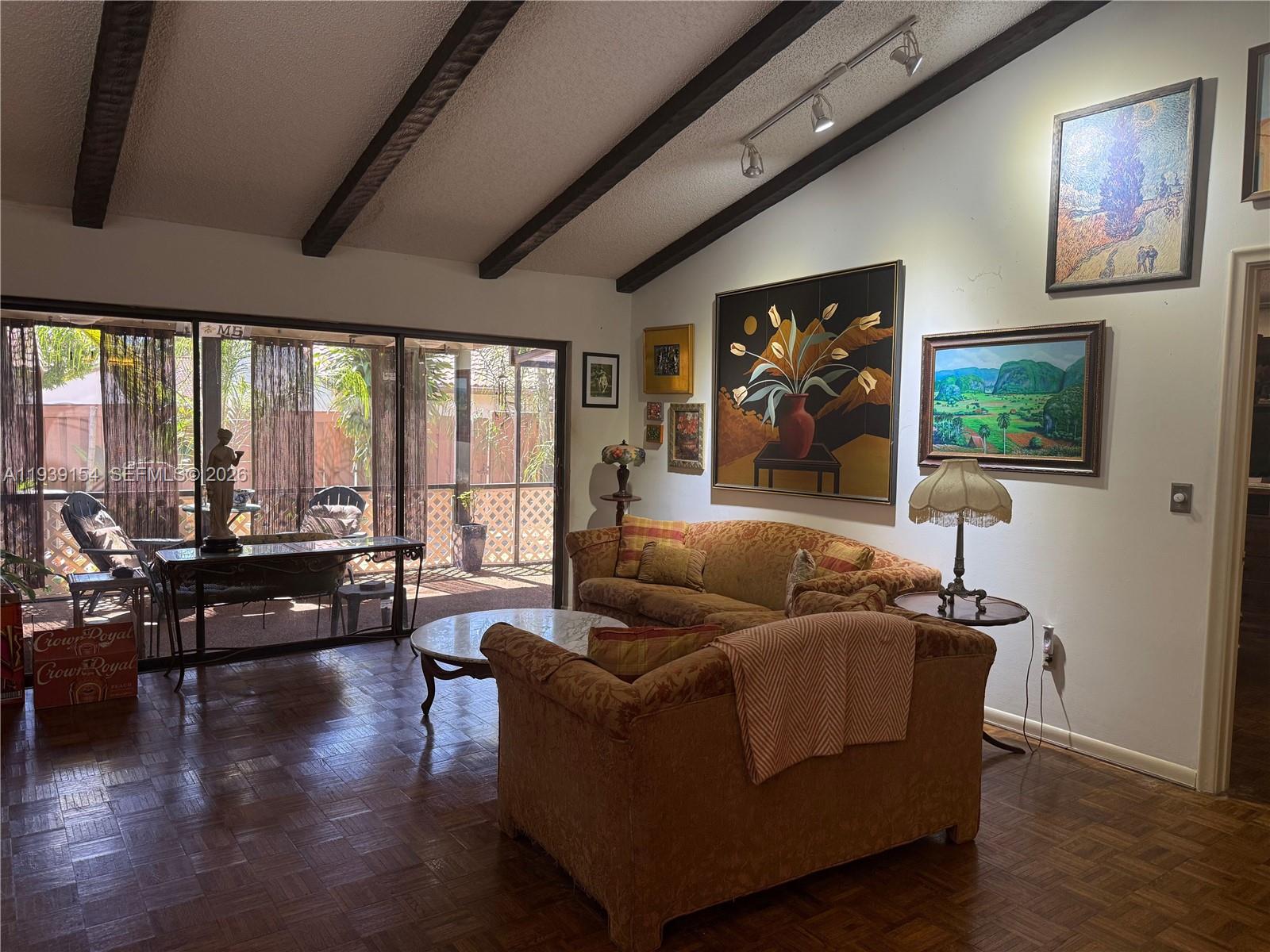 11438 Southwest 86th Lane Miami, FL 33173 - Photo 11 of 17 a living room with furniture and a flat screen tv with wooden floor