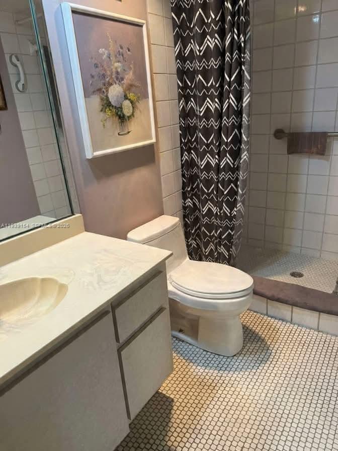 11438 Southwest 86th Lane Miami, FL 33173 - Photo 14 of 17 a bathroom with a toilet and a shower curtain