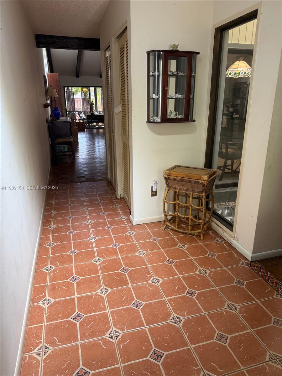 11438 Southwest 86th Lane Miami, FL 33173 - Photo 2 of 17 a view of a workspace with furniture and entryway