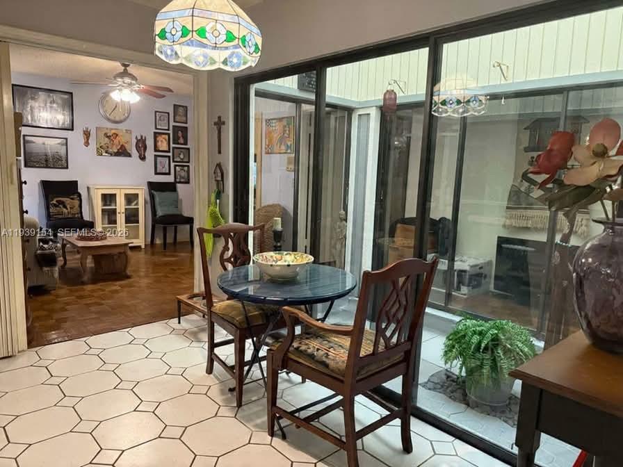 11438 Southwest 86th Lane Miami, FL 33173 - Photo 4 of 17 a view of a dining room with furniture and chandelier