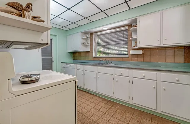 a kitchen with sink cabinets and window