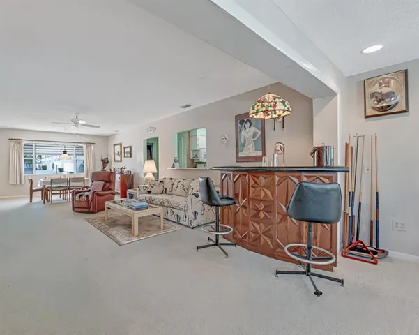 a living room with furniture a rug and a window