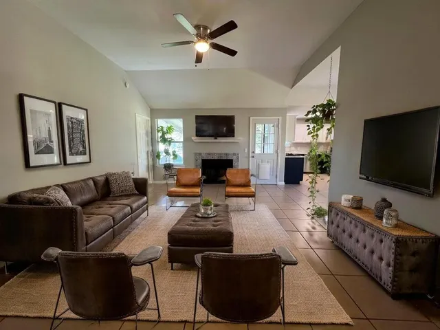a living room with furniture and a fireplace