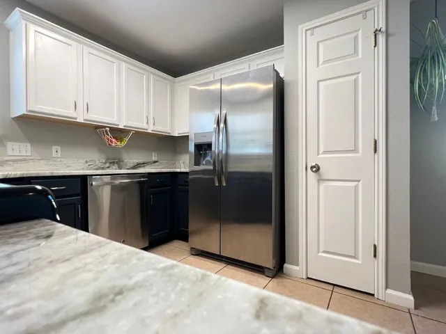 a kitchen with stainless steel appliances a stove a microwave a sink and cabinets