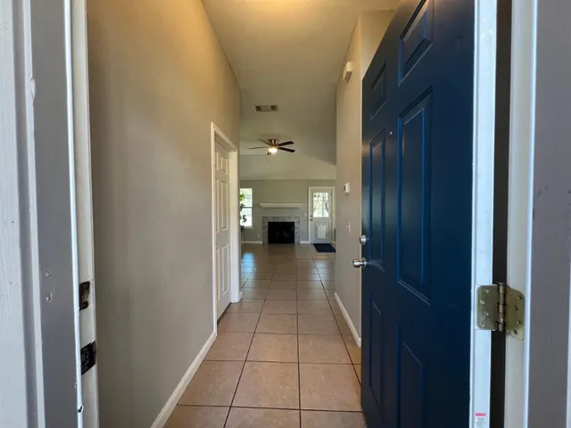 a view of a hallway with seating area