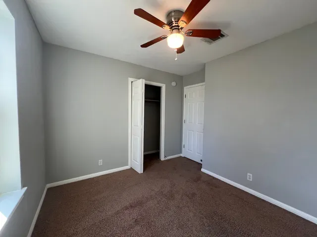 a bedroom with furniture and a flat screen tv